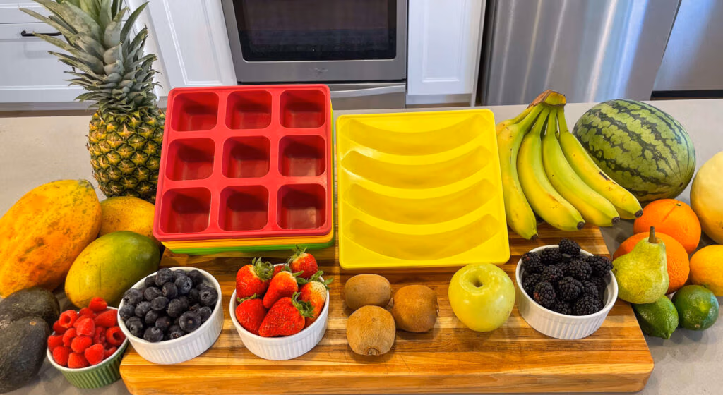 Photo of various fruits laid across a cutting board with Smootheeze freezer trays