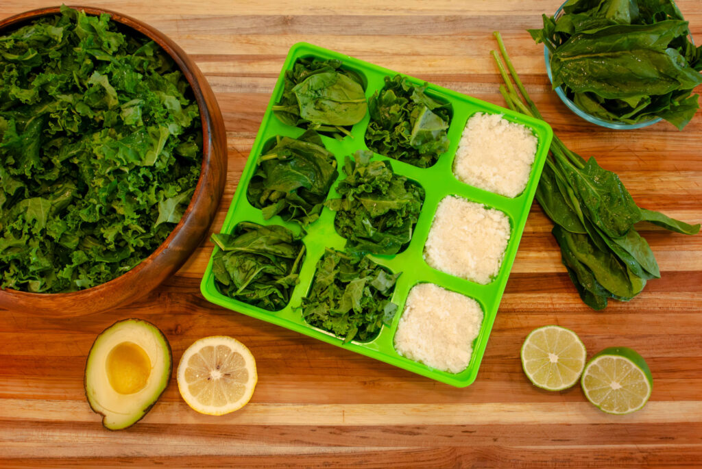 Spinach and Kale added to a smootheeze silicone freezer tray in half cup portions