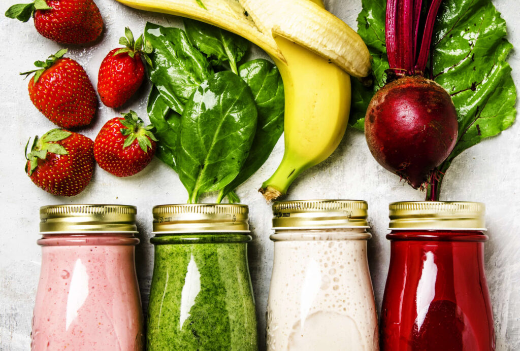 Photo of multicolored smoothies with fresh ingredients