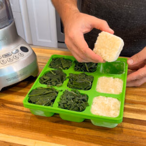 Image of a smootheeze freezer tray with frozen cubes of spinach and cauliflower in it.