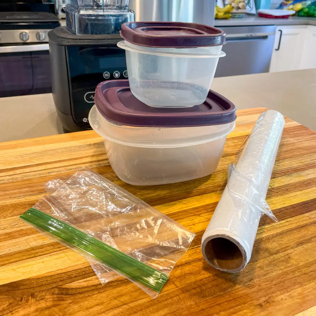 Plastic containers and plastic bags arranged on the counter.