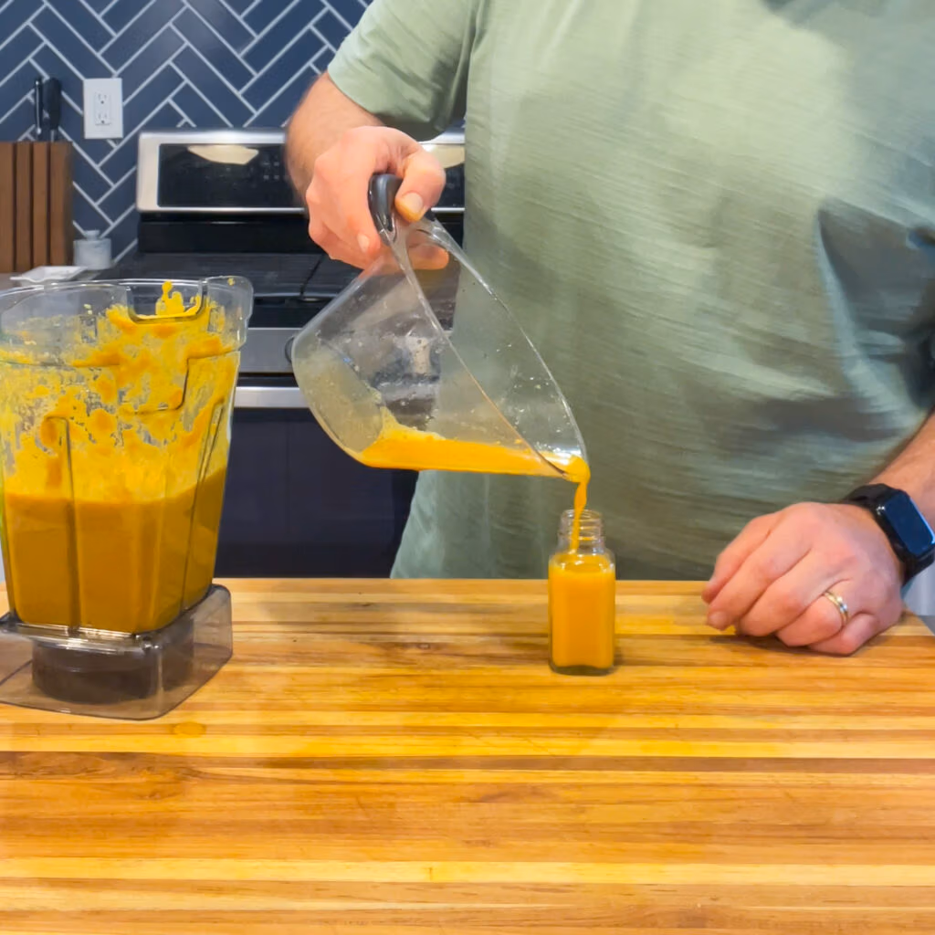 Pouring immunity shot liquid into a small bottle