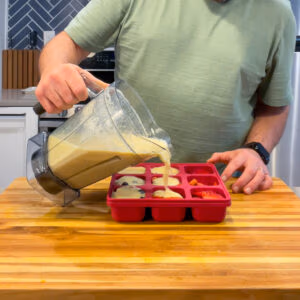 Pouring Immunity Shot Liquid into a Smootheeze Tray.