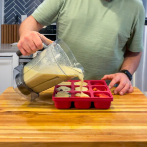 Pouring Immunity Shot Liquid into a Smootheeze Tray.