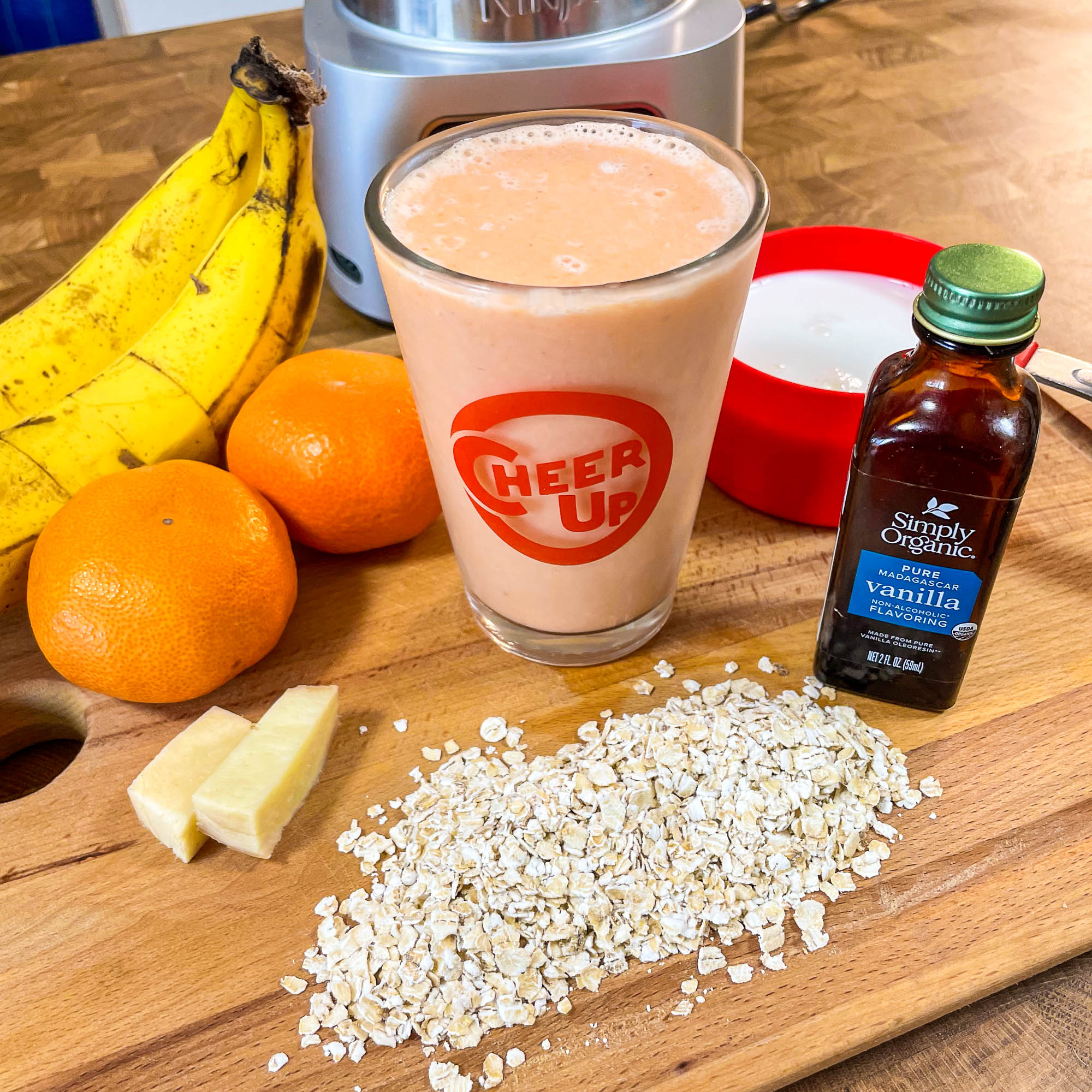 Smoothie in a glass made from oranges, carrots, oats, and ginger