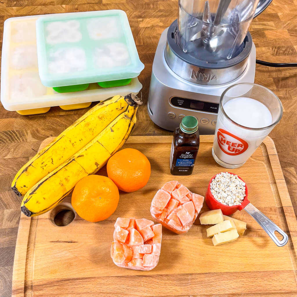 Raw ingredients needed to make and orange carrot smoothie