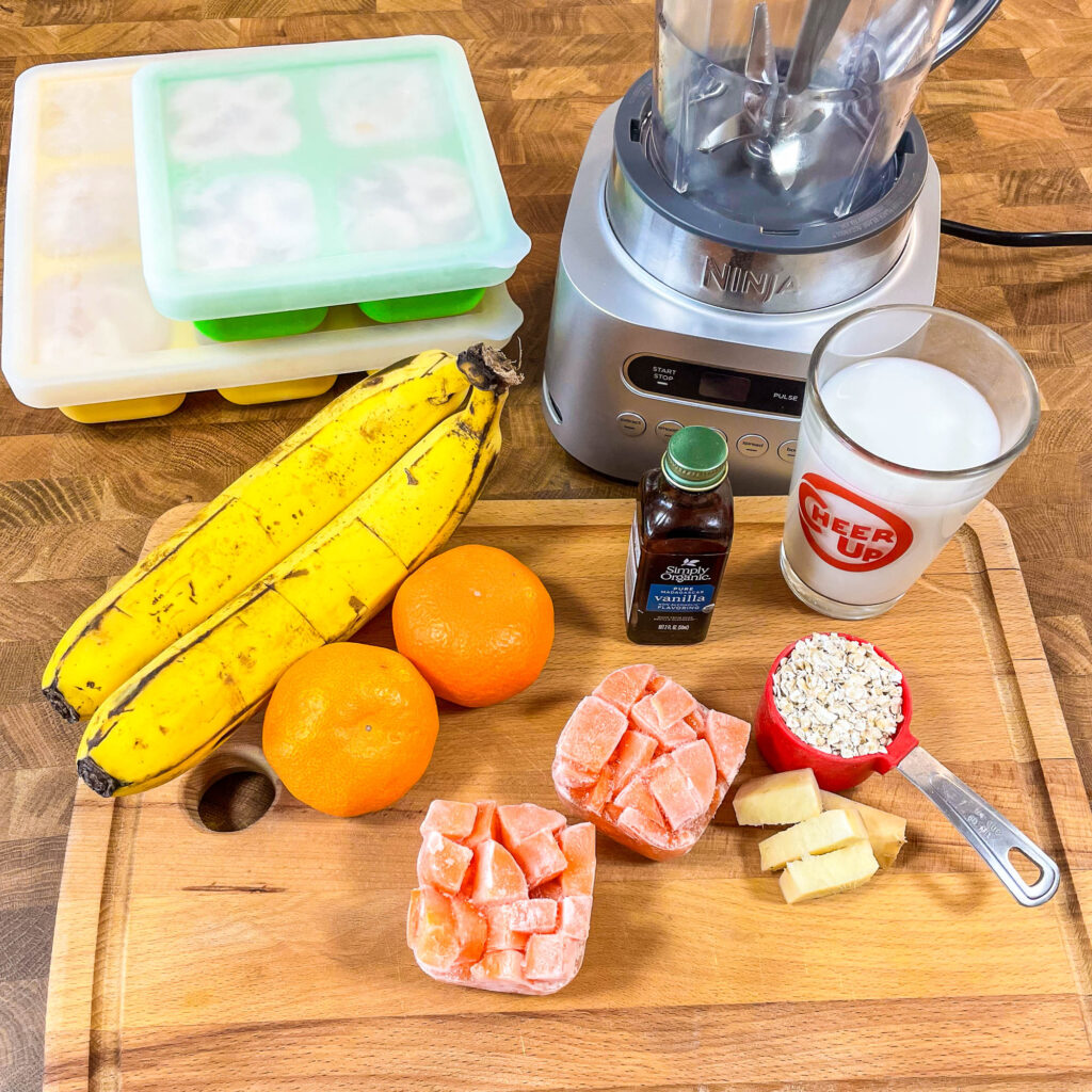 Raw ingredients needed to make and orange carrot smoothie