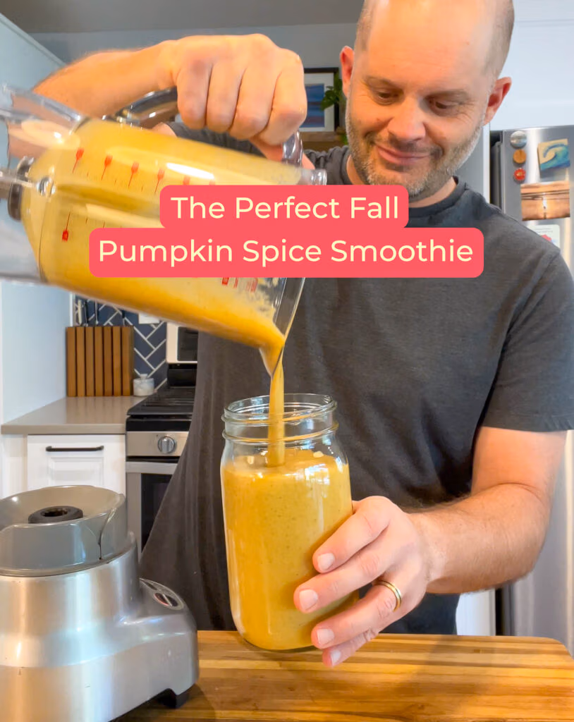 Pouring a smoothie into a glass made pumpkin puree and spices