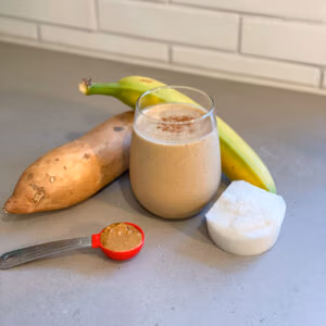 Smoothie in a glass made with sweet potatoes, banana, coconut milk, almond butter.