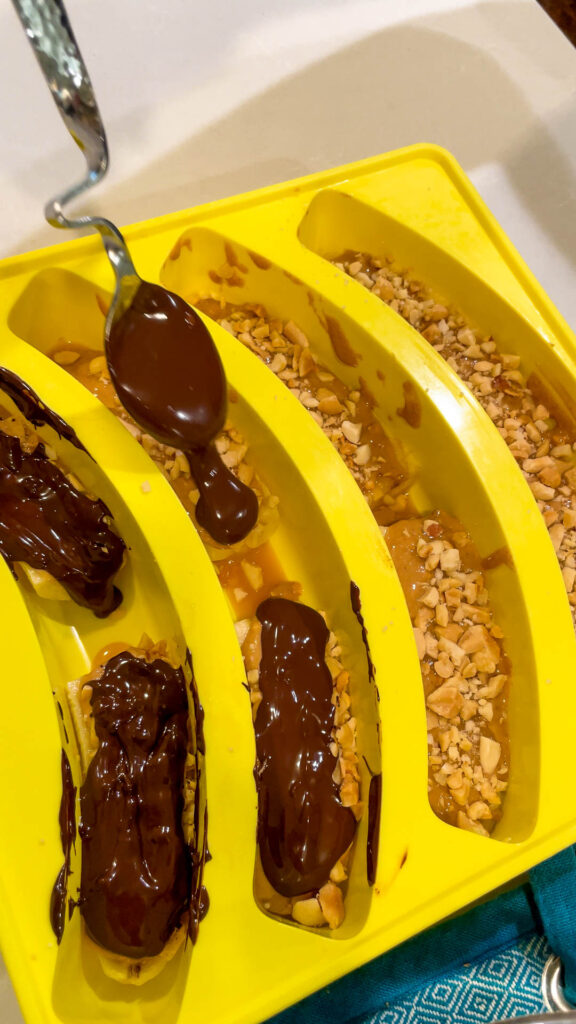 Topping all of the banana base layers with melted chocolate