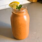 Glass jar on the counter of a watermelon and green tea smoothie