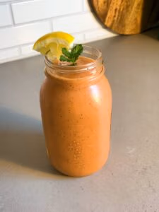Glass jar on the counter of a watermelon and green tea smoothie